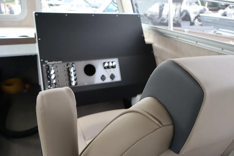 Slide: The Image of Interior of 2026 KingFisher 3025 XRS boat, featuring a modern control panel and comfortable seating. - 13