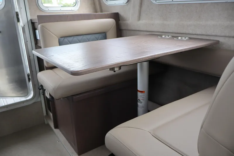 Slide: The Image of Interior of 2026 KingFisher 3025 XRS boat with beige seating and wooden table. - 18
