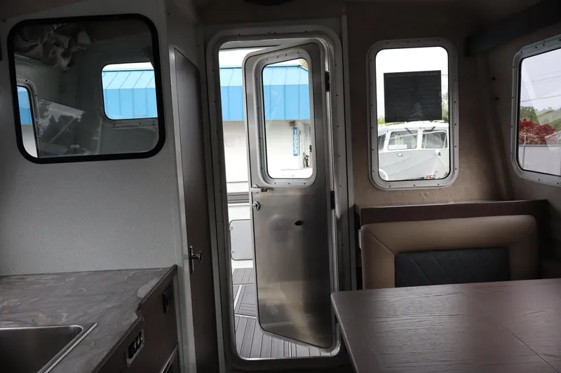 Slide: The Image of Interior view of 2026 KingFisher 3025 XRS boat, featuring seating and open door. - 19