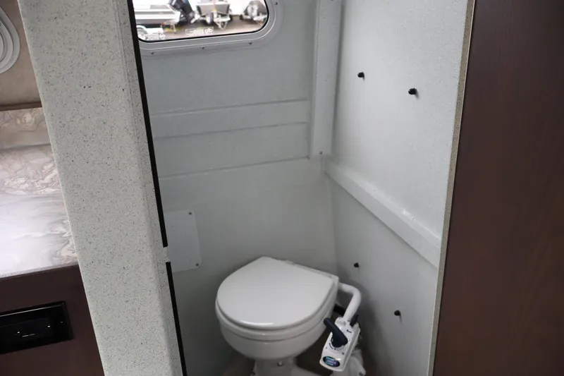 Slide: The Image of Compact bathroom in 2026 KingFisher 3025 XRS boat, featuring a modern toilet. - 20