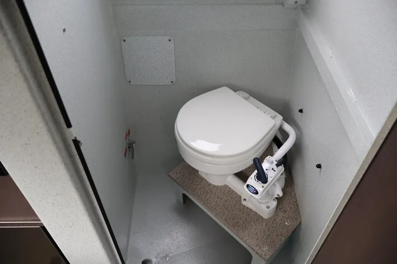 Slide: The Image of Compact marine toilet in KingFisher 3025 XRS, 2026 model, featuring manual flush system. - 21