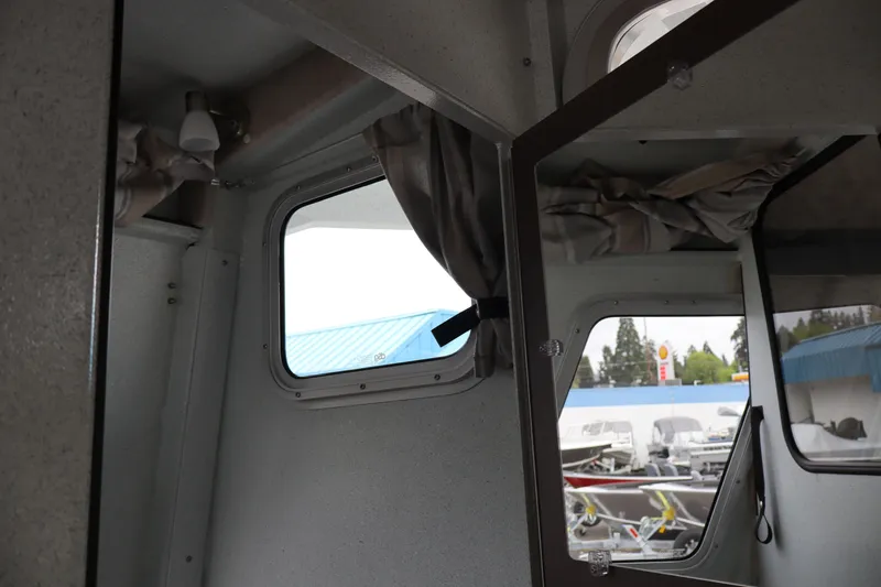 Slide: The Image of Interior view of 2026 KingFisher 3025 XRS boat, showcasing windows and curtains. - 22