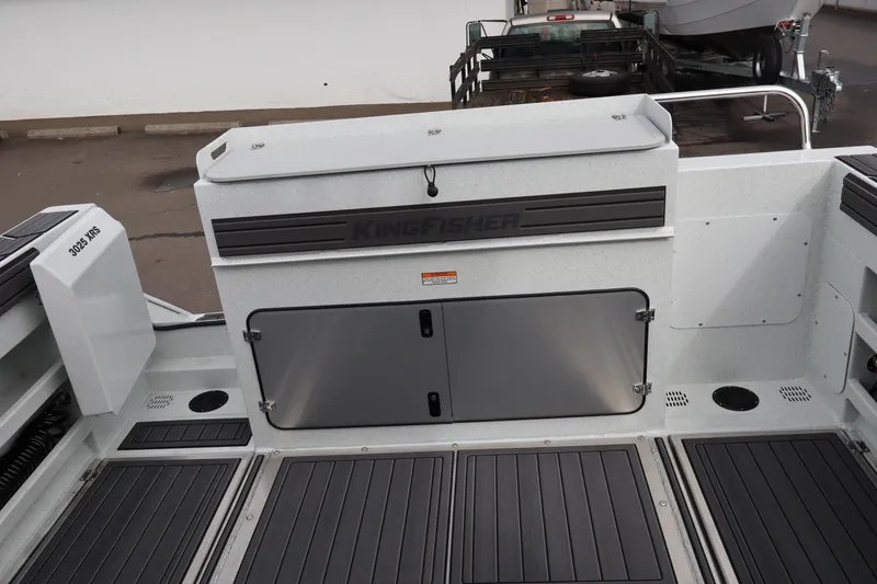 Slide: The Image of 2026 KingFisher 3025 XRS boat interior with storage compartments and sleek design. - 7