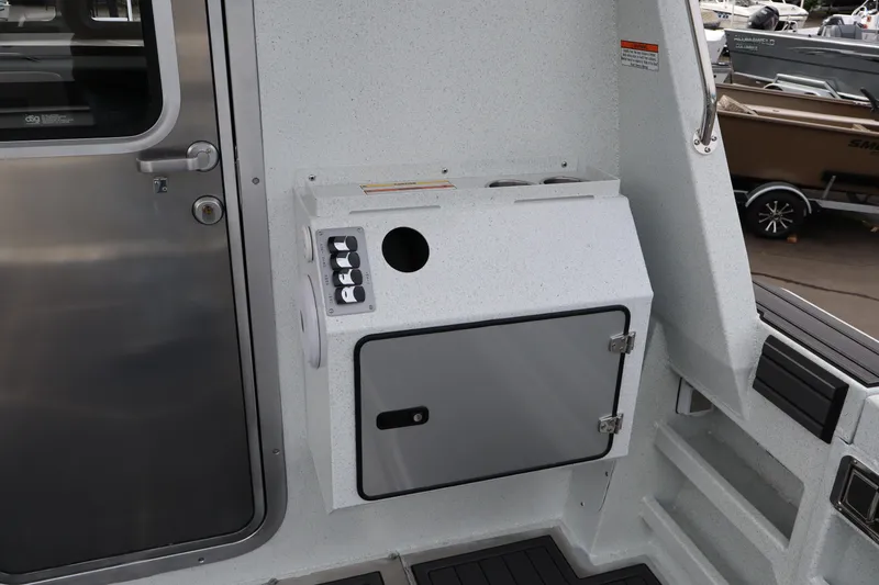 Slide: The Image of Interior view of 2026 KingFisher 3025 XRS boat, featuring a control panel and storage compartment. - 9