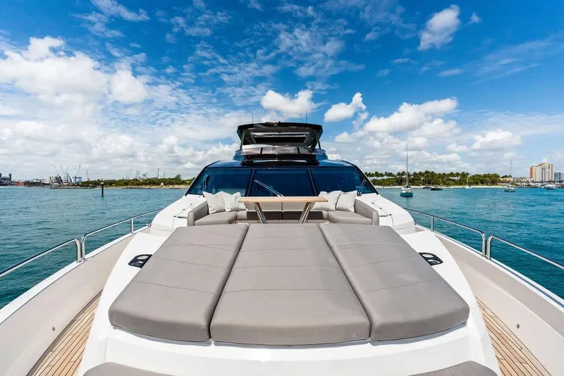 Slide: The Image of Luxurious 2026 Sunseeker 88 Yacht on serene blue waters under a vibrant sky. - 10