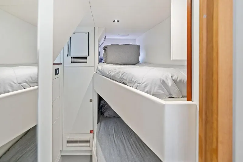 Slide: The Image of Interior of 2026 Sunseeker 88 Yacht featuring modern bunk beds in a compact cabin. - 100
