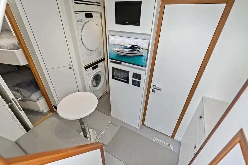 Slide: The Image of Interior of 2026 Sunseeker 88 Yacht featuring laundry appliances and modern amenities. - 102