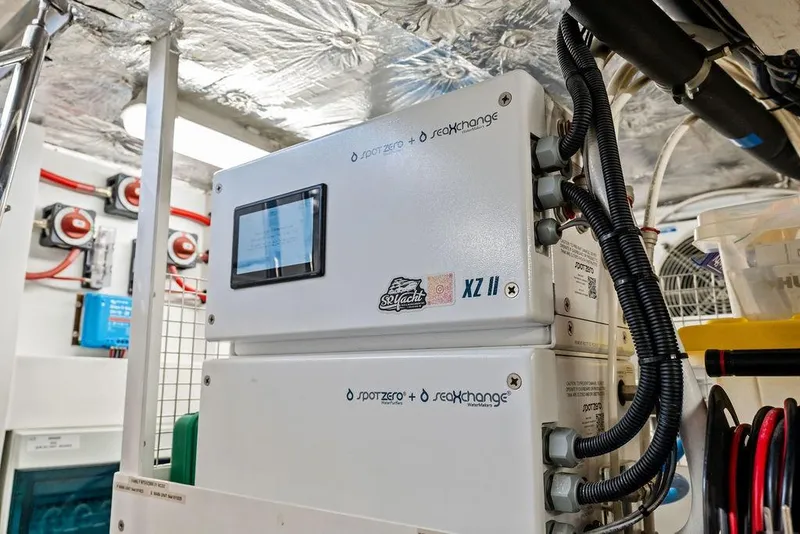 Slide: The Image of Electrical equipment inside a 2026 Sunseeker 88 Yacht, featuring control panels and wiring. - 110