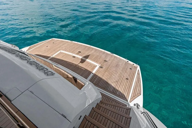 Slide: The Image of Luxurious Sunseeker 88 Yacht 2026 with teak deck overlooking clear blue ocean waters. - 15
