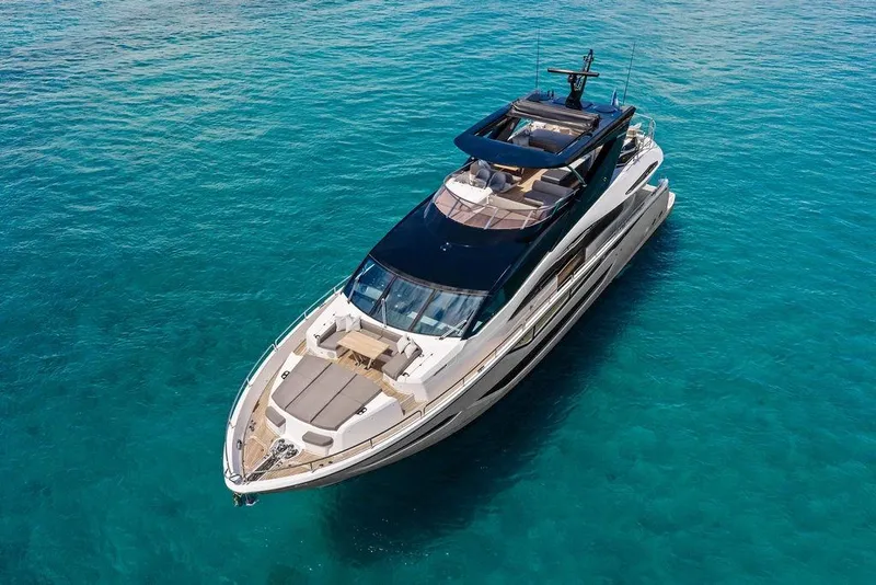 Slide: The Image of Luxurious 2026 Sunseeker 88 Yacht cruising on clear blue waters. - 2