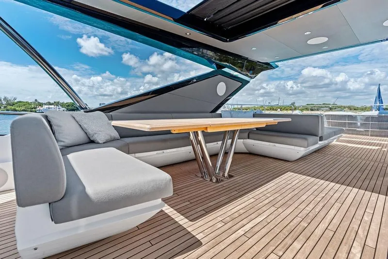 Slide: The Image of Luxurious Sunseeker 88 Yacht 2026 deck with modern seating and table under open sky. - 33