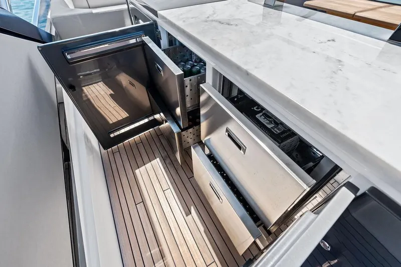 Slide: The Image of Luxury Sunseeker 88 Yacht 2026 interior with open stainless steel drawers and marble countertop. - 36