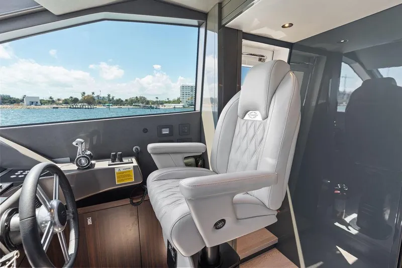 Slide: The Image of Luxurious helm seat on 2026 Sunseeker 88 Yacht, overlooking scenic ocean view. - 52