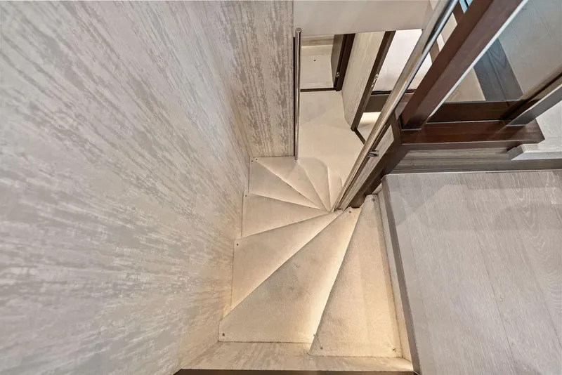Slide: The Image of Elegant spiral staircase inside 2026 Sunseeker 88 Yacht, featuring modern design and wood accents. - 58
