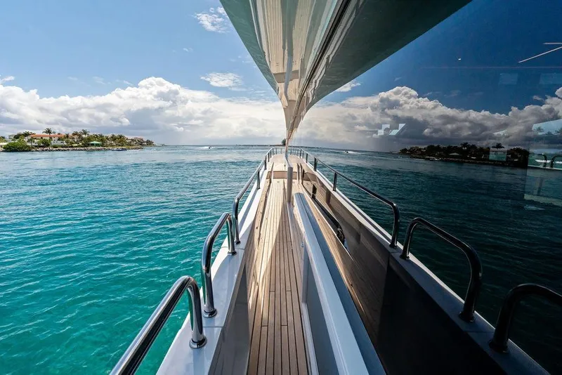 Slide: The Image of 2026 Sunseeker 88 Yacht cruising on clear blue waters under a partly cloudy sky. - 7