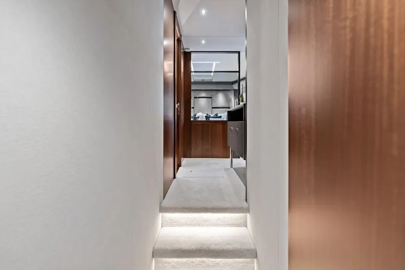 Slide: The Image of Interior hallway of 2026 Sunseeker 88 Yacht with modern design and wooden accents. - 76