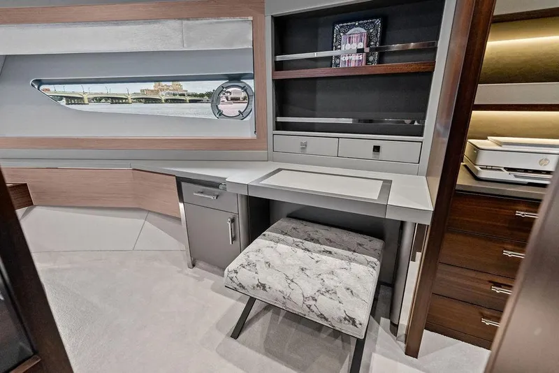 Slide: The Image of Luxurious interior of 2026 Sunseeker 88 Yacht with modern desk and scenic window view. - 83