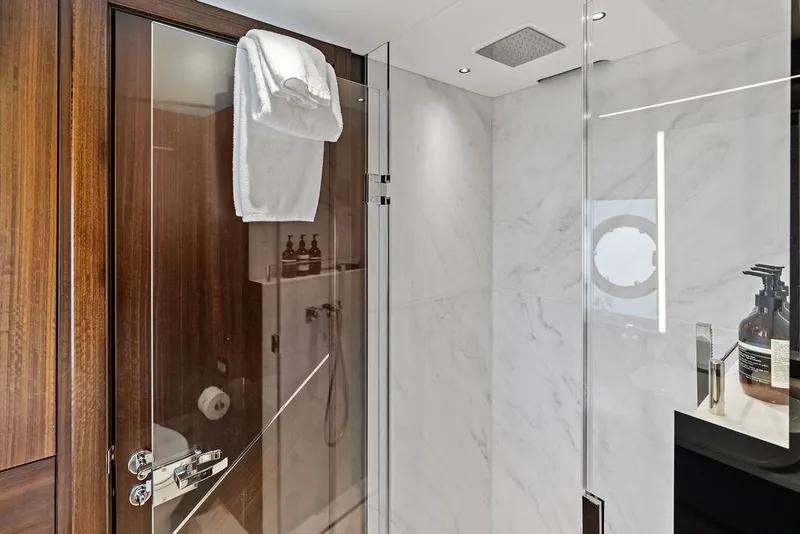 Slide: The Image of Luxurious bathroom in 2026 Sunseeker 88 Yacht with glass shower and wooden accents. - 87