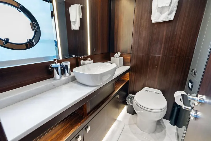 Slide: The Image of Luxurious bathroom in 2026 Sunseeker 88 Yacht with modern fixtures and elegant wood paneling. - 92