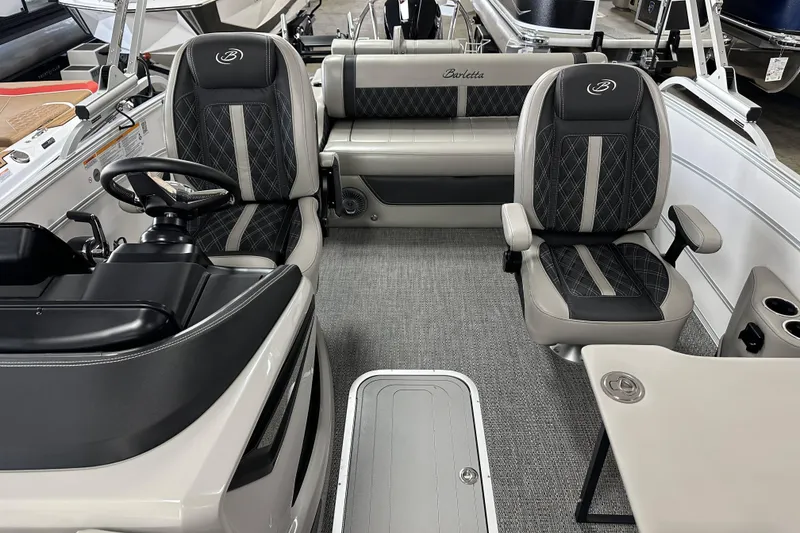 Slide: The Image of 2026 Barletta Lusso boat interior with luxurious seating and modern steering console. - 5