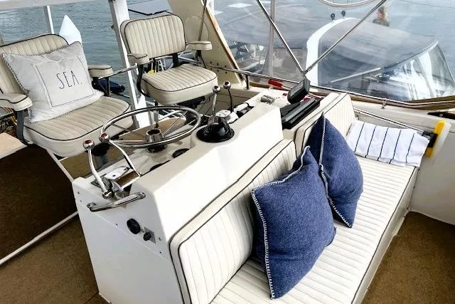 Slide: The Image of 1980 Viking 43 Convertible yacht interior with helm, seating, and nautical decor. - 10