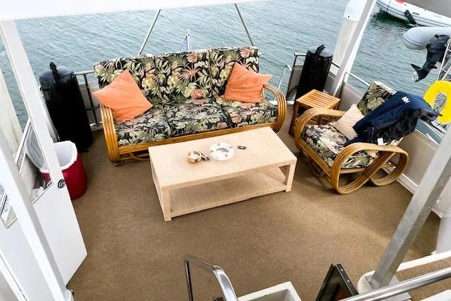 Slide: The Image of Cozy seating area on 1980 Viking 43 Convertible yacht with floral cushions and wooden furniture. - 11