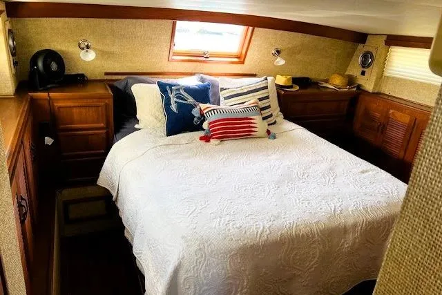 Slide: The Image of Cozy bedroom in 1980 Viking 43 Convertible yacht with nautical-themed pillows. - 12