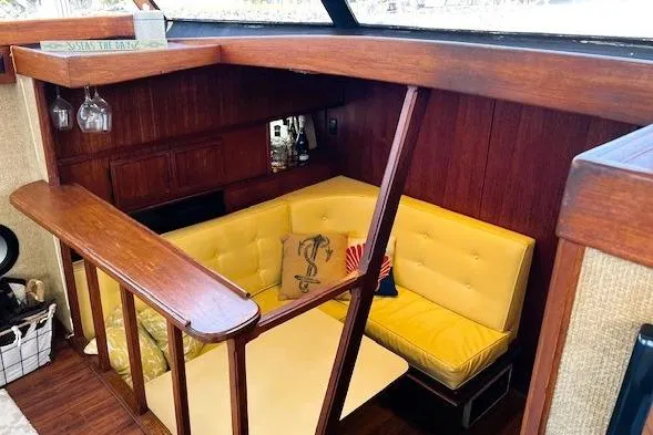 Slide: The Image of Interior of 1980 Viking 43 Convertible yacht with yellow seating and wooden accents. - 14
