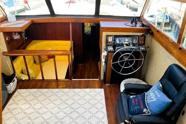 Slide: The Image of Interior of a 1980 Viking 43 Convertible yacht with helm, seating, and cozy cabin area. - 16