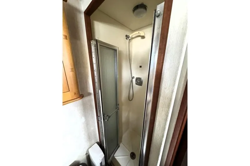 Slide: The Image of Shower area inside a 1980 Viking 43 Convertible boat, featuring a compact design. - 20
