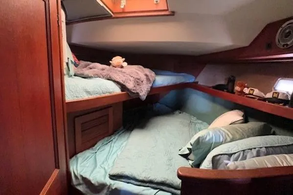 Slide: The Image of Cozy cabin interior of 1980 Viking 43 Convertible yacht with bunk beds and wooden finish. - 21