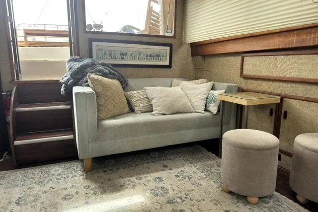 Slide: The Image of Cozy interior of a 1980 Viking 43 Convertible yacht with sofa and decor. - 22