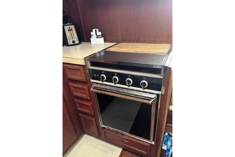 Slide: The Image of 1980 Viking 43 Convertible kitchen with vintage stove and wooden cabinetry. - 26