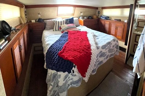 Slide: The Image of Interior of a 1980 Viking 43 Convertible yacht with helm, seating, and cozy cabin area. - 27