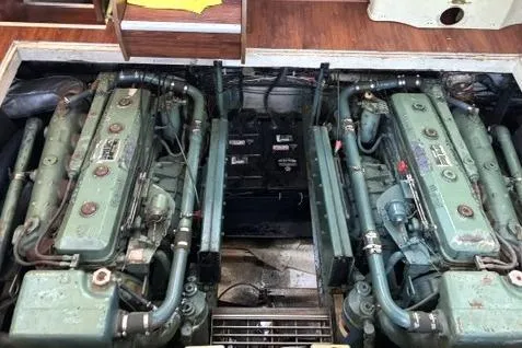 Slide: The Image of Engine room of a 1980 Viking 43 Convertible boat, showcasing dual engines. - 29