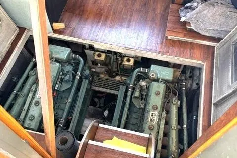 Slide: The Image of Engine room of a 1980 Viking 43 Convertible boat, showcasing dual engines. - 30