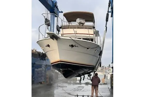 Slide: The Image of 1980 Viking 43 Convertible yacht on water, featuring a spacious deck and classic design. - 6