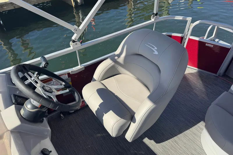 Slide: The Image of 2023 Bennington 188 SVF boat interior with steering wheel and comfortable seating. - 13