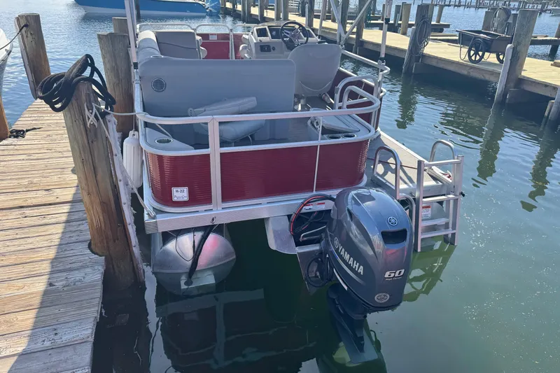 Slide: The Image of 2023 Bennington 188 SVF pontoon boat docked with Yamaha 60 outboard motor. - 14