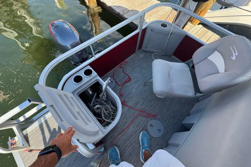 Slide: The Image of 2023 Bennington 188 SVF boat interior with seating, storage, and motor view. - 3