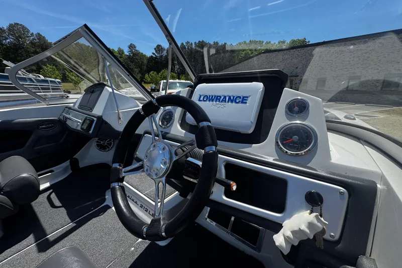 Slide: The Image of 2018 Ranger 212LS Reata boat dashboard with steering wheel and Lowrance HDS display. - 10