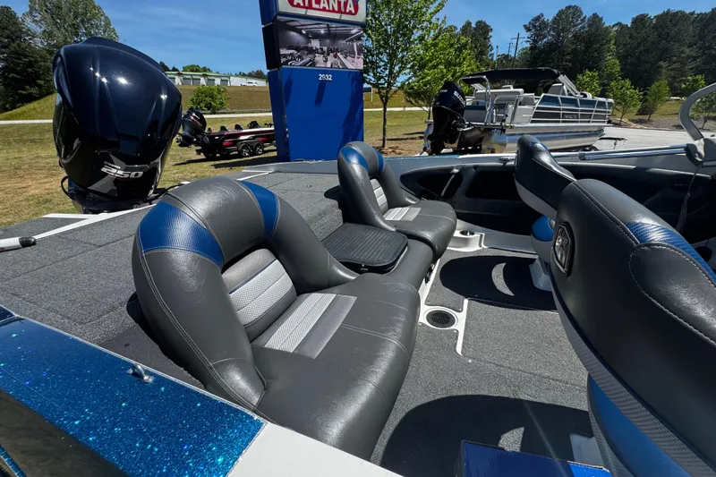 Slide: The Image of 2018 Ranger 212LS Reata boat interior with leather seats and powerful outboard motor. - 12