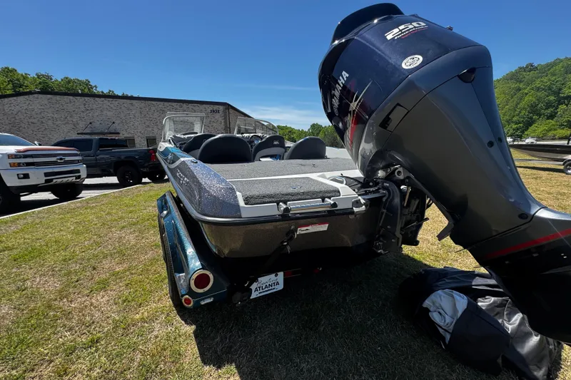 Slide: The Image of 2018 Ranger 212LS Reata boat with Yamaha 250 engine, parked outdoors on grass. - 16