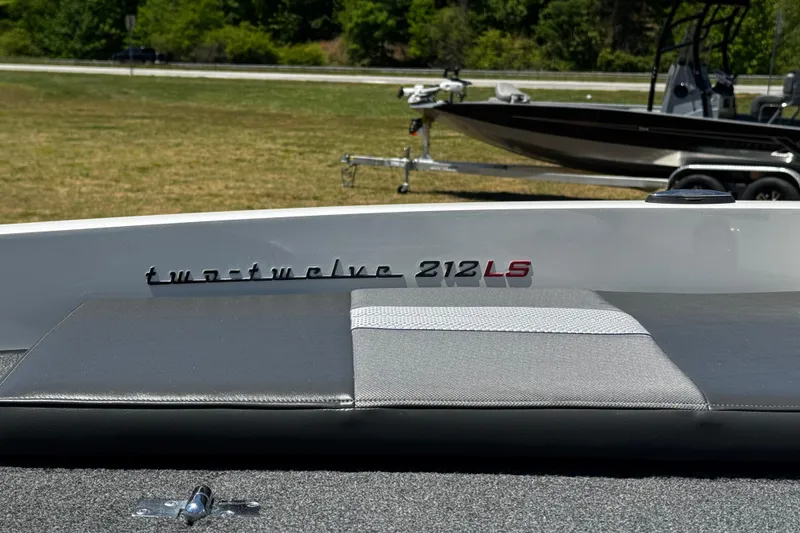 Slide: The Image of 2018 Ranger 212LS Reata boat on display outdoors. - 4