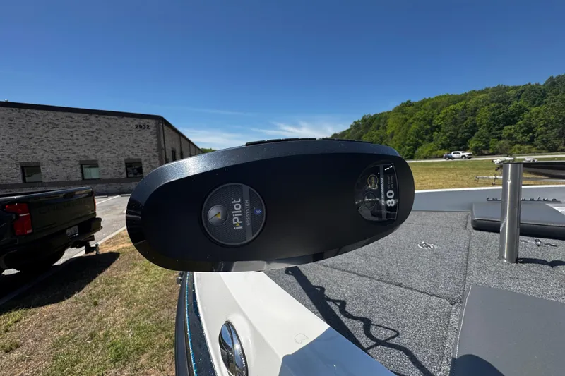 Slide: The Image of 2018 Ranger 212LS Reata boat with iPilot system, parked outdoors on a sunny day. - 6
