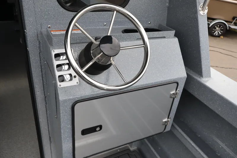 Slide: The Image of Steering console of 2026 KingFisher 2825 Coastal Express boat, featuring sleek design. - 10