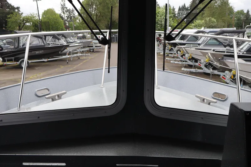 Slide: The Image of Interior view from 2026 KingFisher 2825 Coastal Express boat, showcasing marina and parked boats. - 14