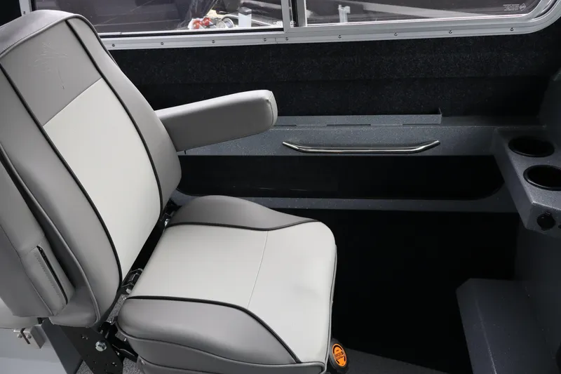 Slide: The Image of 2026 KingFisher 2825 Coastal Express interior seat with armrest and cup holders. - 18