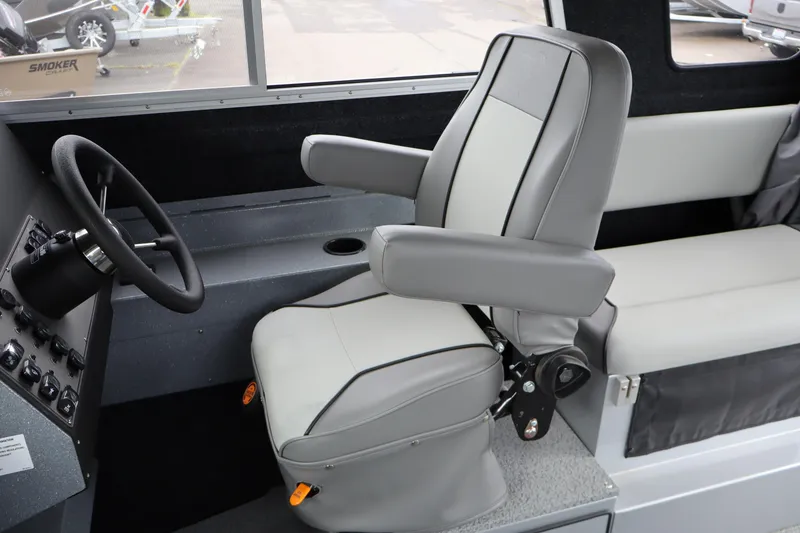 Slide: The Image of Captain's chair and steering wheel in 2026 KingFisher 2825 Coastal Express boat interior. - 19