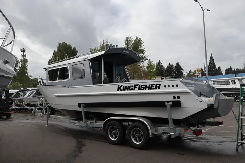 Slide: The Image of 2026 KingFisher 2825 Coastal Express boat on trailer, parked outdoors. - 3